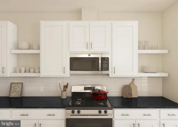 a kitchen with granite countertop white cabinets and black appliances