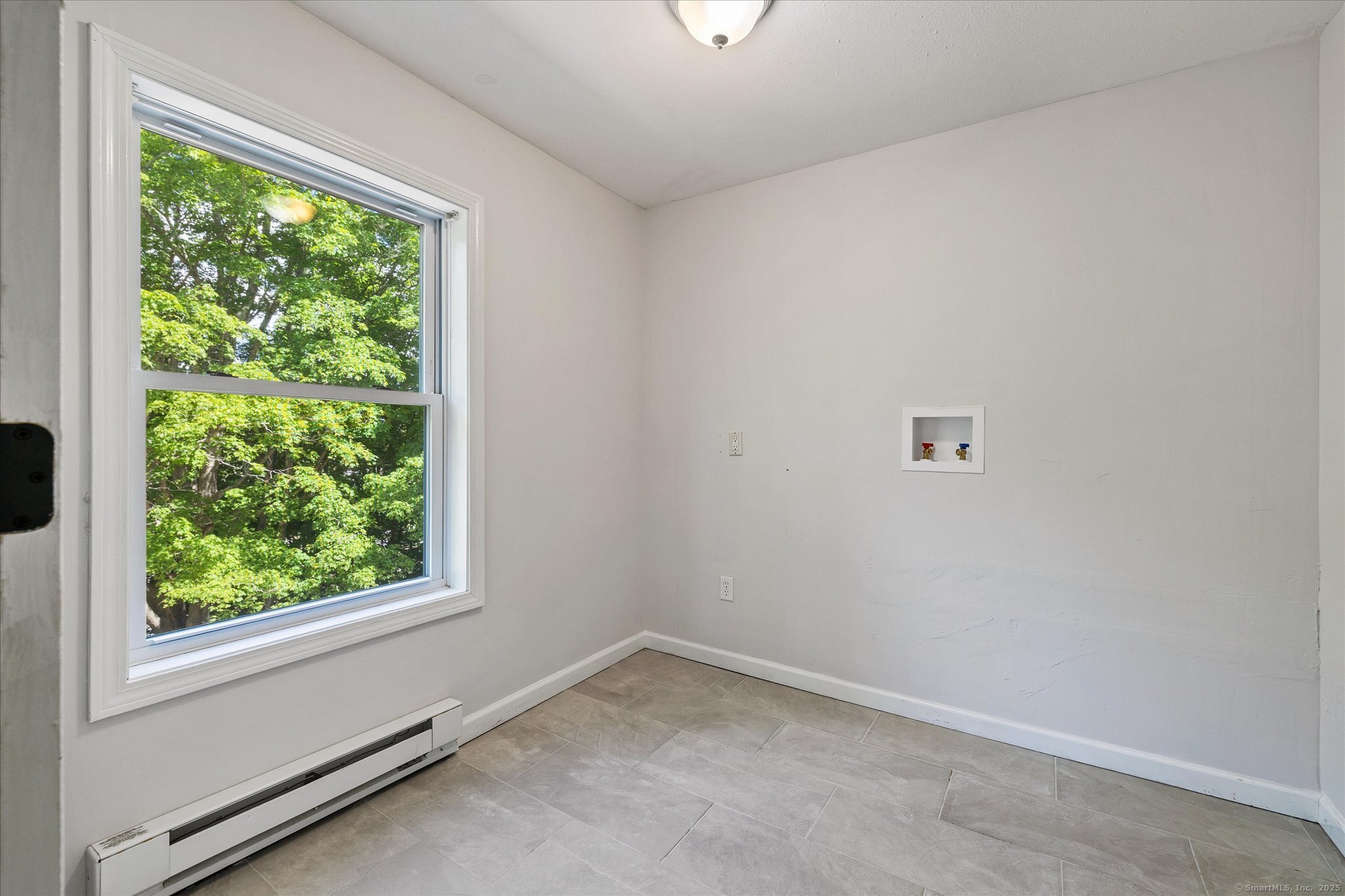 34 Pleasant Street, Unit 5 Plainfield, CT 06374 - Photo 16 of 24 an empty room with a window