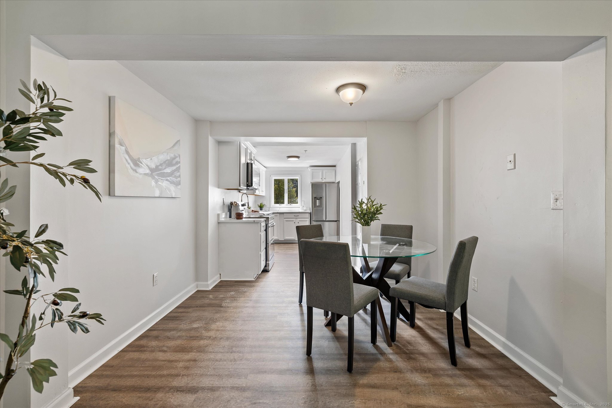 34 Pleasant Street, Unit 5 Plainfield, CT 06374 - Photo 9 of 24 a view of a dining room with furniture window and wooden floor