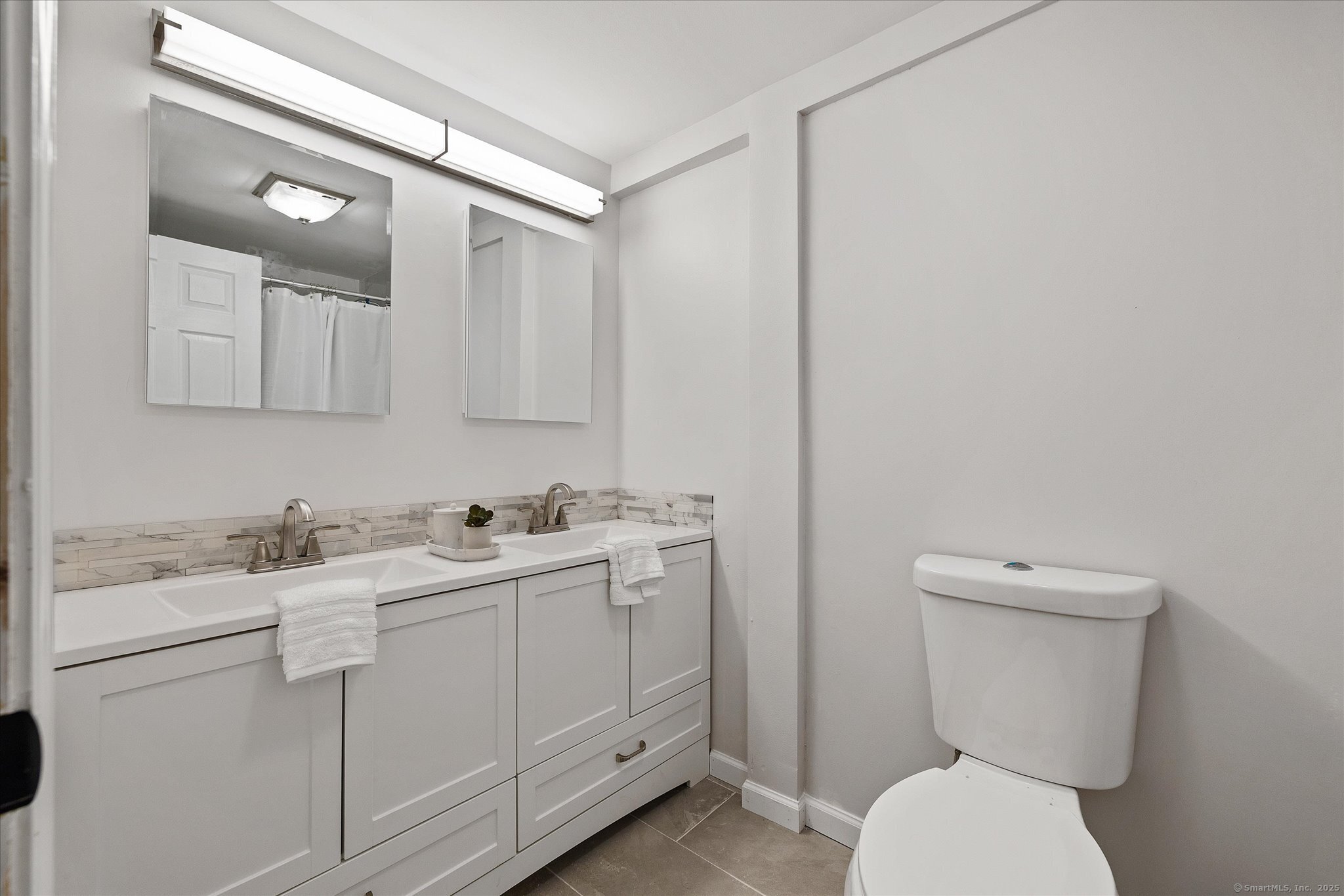 34 Pleasant Street, Unit 5 Plainfield, CT 06374 - Photo 10 of 24 a bathroom with a toilet sink and mirror