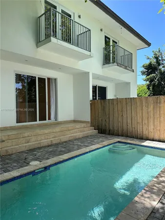 a front view of a house with a garden and yard