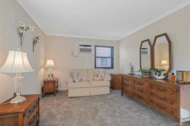 a living room with furniture a lamp and a large window