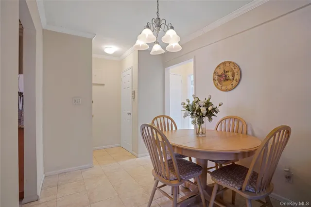 a dining room with furniture and a chandelier