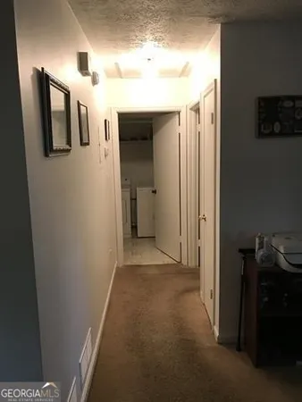 a view of a hallway with closet and entryway
