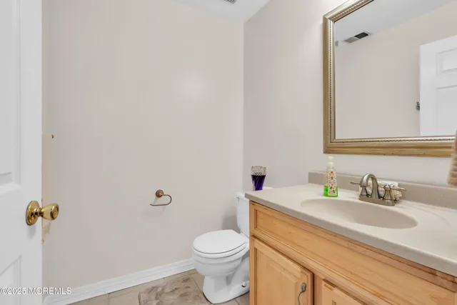 a bathroom with a sink and mirror with toilet