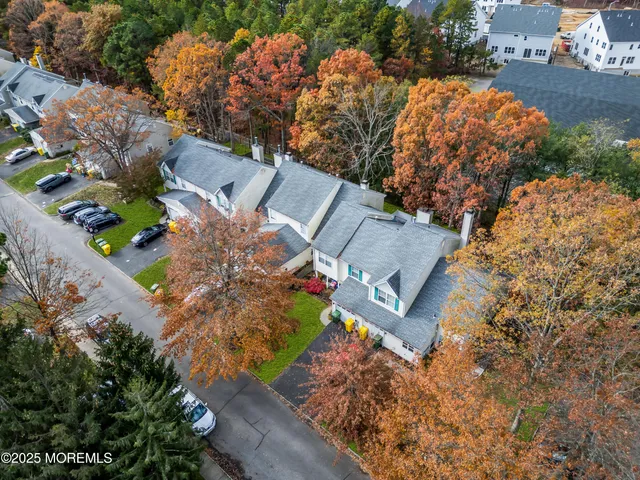 an aerial view of a residential houses with outdoor space