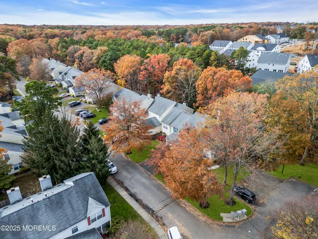 an aerial view of residential houses with outdoor space