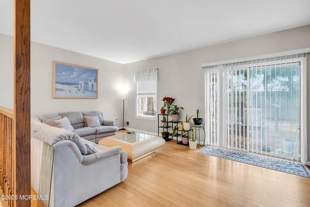 a living room with furniture and large windows