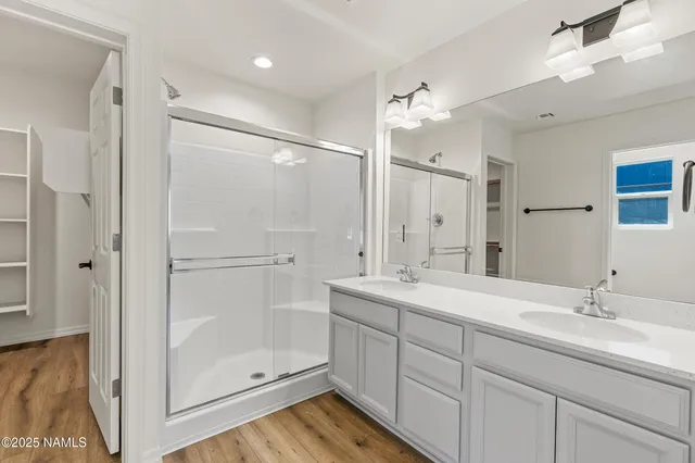 a view of a bathroom with closet and mirror