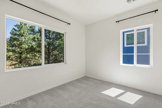 a bedroom with a large bed and a flat screen tv