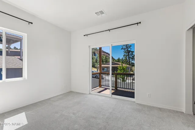 a view of a house with a yard and potted plants