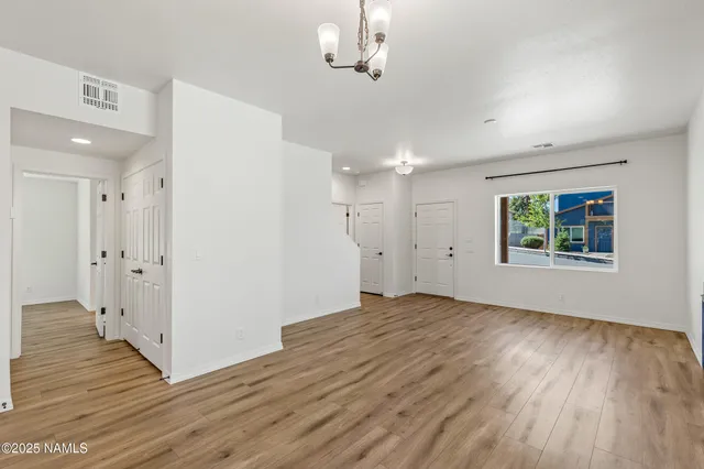 a large kitchen with stainless steel appliances granite countertop a large counter top a sink and a refrigerator