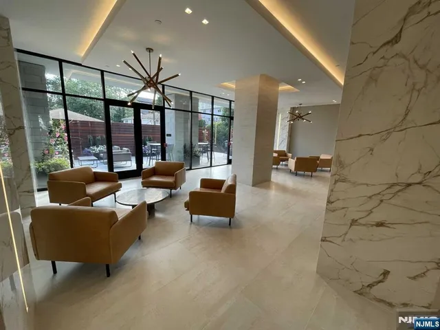 a view of a livingroom with furniture window and wooden floor
