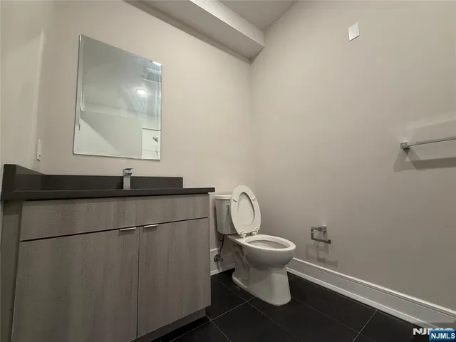 a bathroom with a sink toilet and mirror