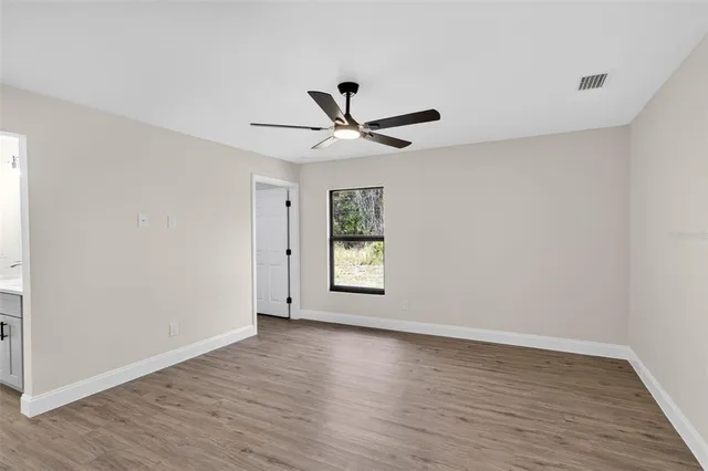 a white house that has a tree in front of it