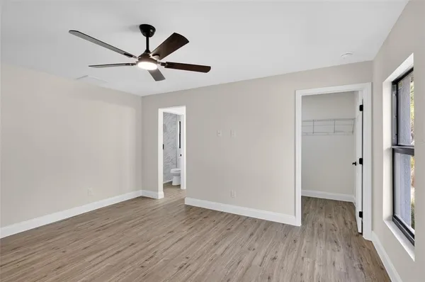 an aerial view of residential houses with outdoor space and trees
