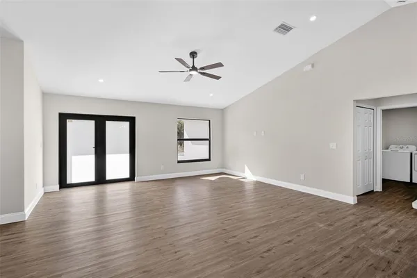 a kitchen with kitchen island white cabinets and stainless steel appliances