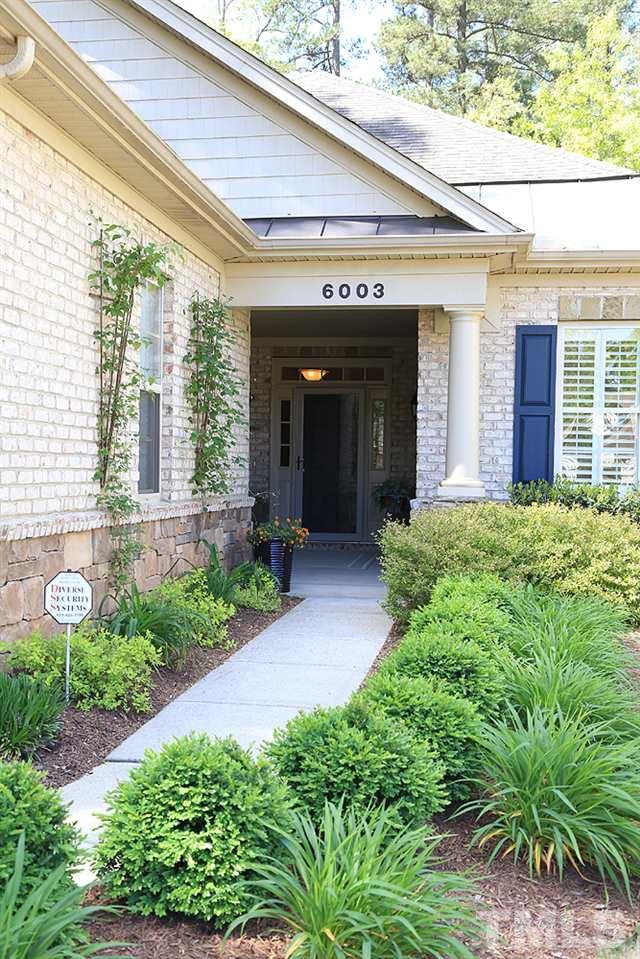 6003 Magenta Court Raleigh, NC 27617 - Photo 2 of 30 a view of a house with potted plants and a bench