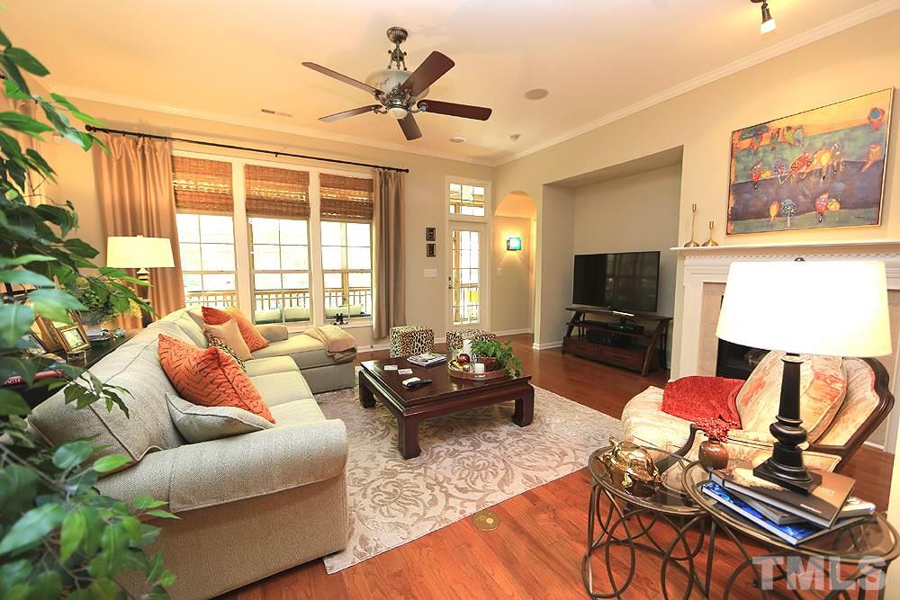 6003 Magenta Court Raleigh, NC 27617 - Photo 13 of 30 a living room with furniture a flat screen tv and a large window