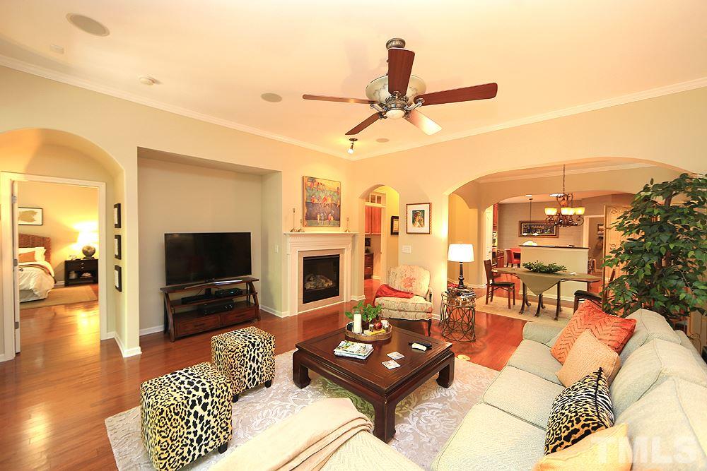 6003 Magenta Court Raleigh, NC 27617 - Photo 15 of 30 a living room with furniture a flat screen tv and a fireplace
