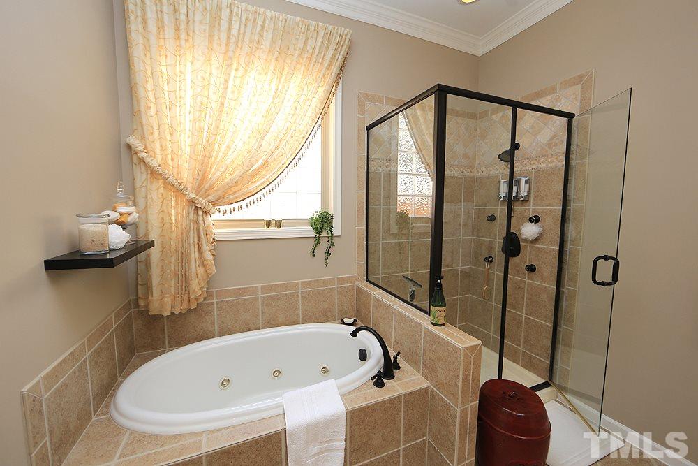 6003 Magenta Court Raleigh, NC 27617 - Photo 19 of 30 a bathroom with a tub and a window