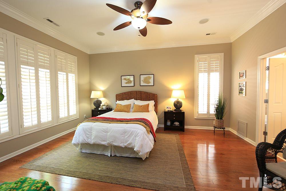 6003 Magenta Court Raleigh, NC 27617 - Photo 21 of 30 a bedroom with a bed and wooden floor