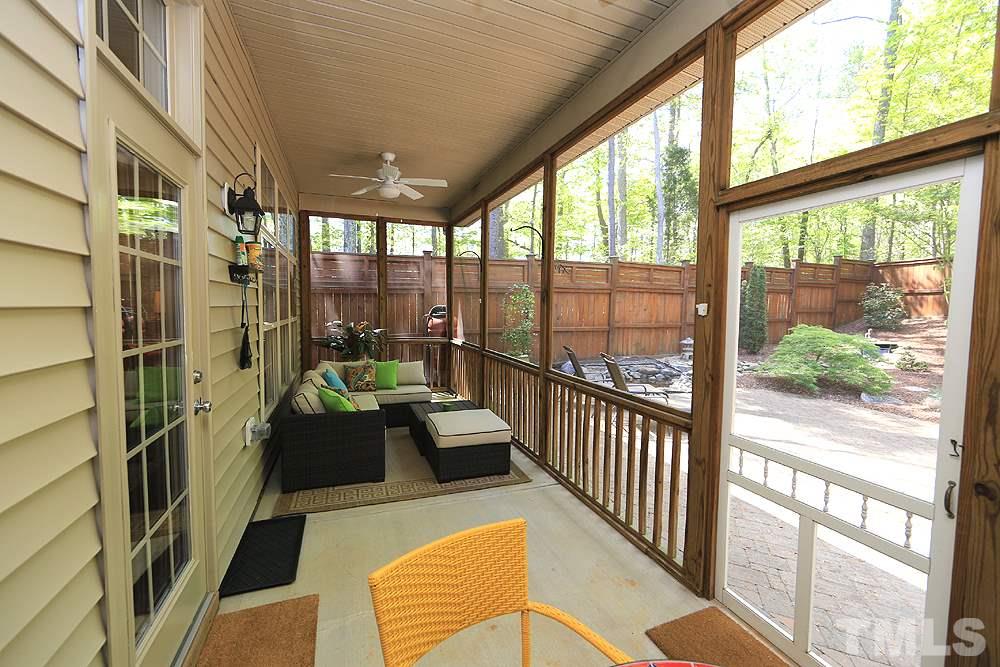 6003 Magenta Court Raleigh, NC 27617 - Photo 25 of 30 a living room with large windows and a table