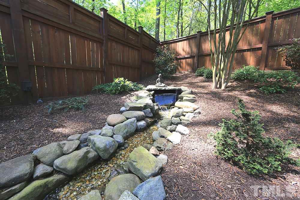 6003 Magenta Court Raleigh, NC 27617 - Photo 27 of 30 a backyard of a house with lots of green space