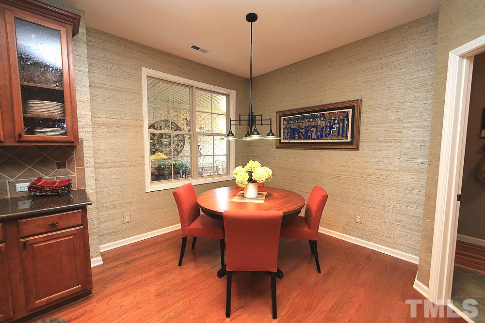 6003 Magenta Court Raleigh, NC 27617 - Photo 5 of 30 a dining room with furniture a chandelier and wooden floor