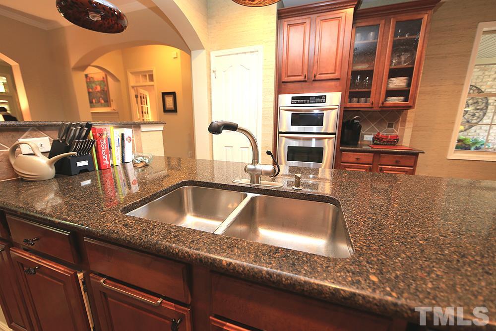 6003 Magenta Court Raleigh, NC 27617 - Photo 7 of 30 a kitchen with granite countertop a sink and a stove