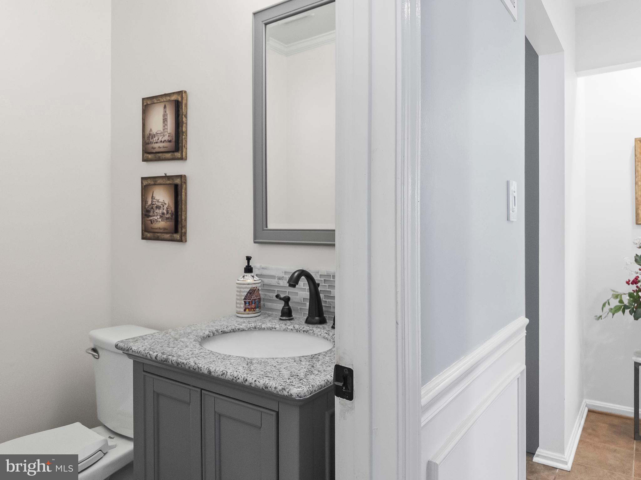 21600 Glendalough Road Gaithersburg, MD 20882 - Photo 29 of 64 a bathroom with a granite countertop sink and a mirror