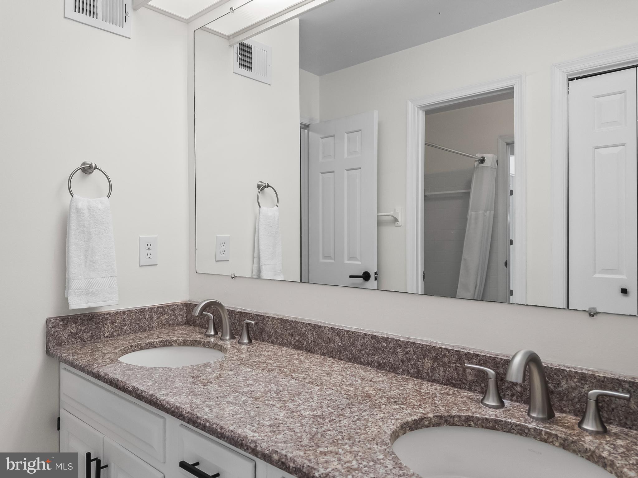21600 Glendalough Road Gaithersburg, MD 20882 - Photo 42 of 64 a bathroom with a granite countertop sink and a mirror