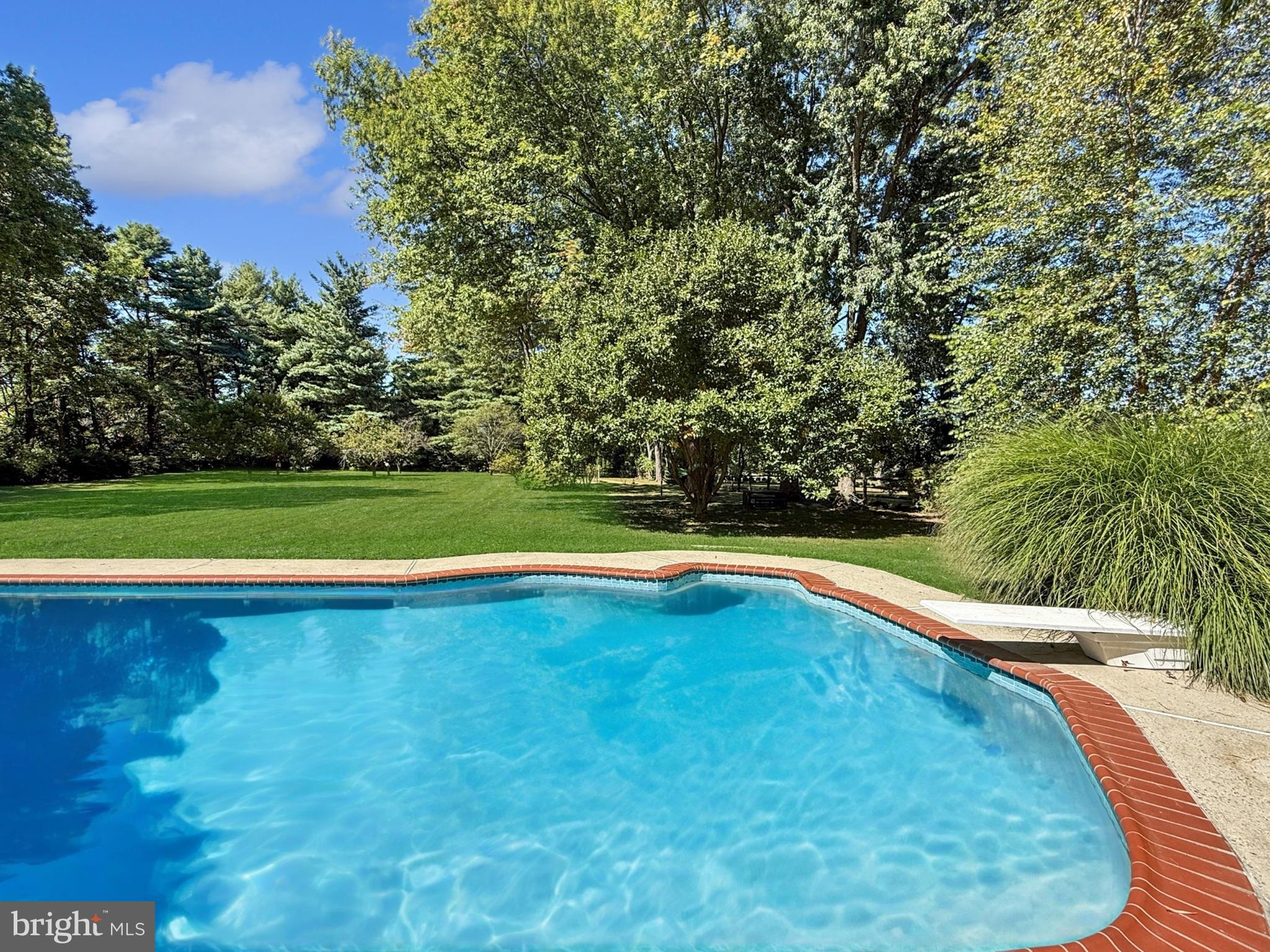21600 Glendalough Road Gaithersburg, MD 20882 - Photo 8 of 64 a view of a swimming pool and trees in the background