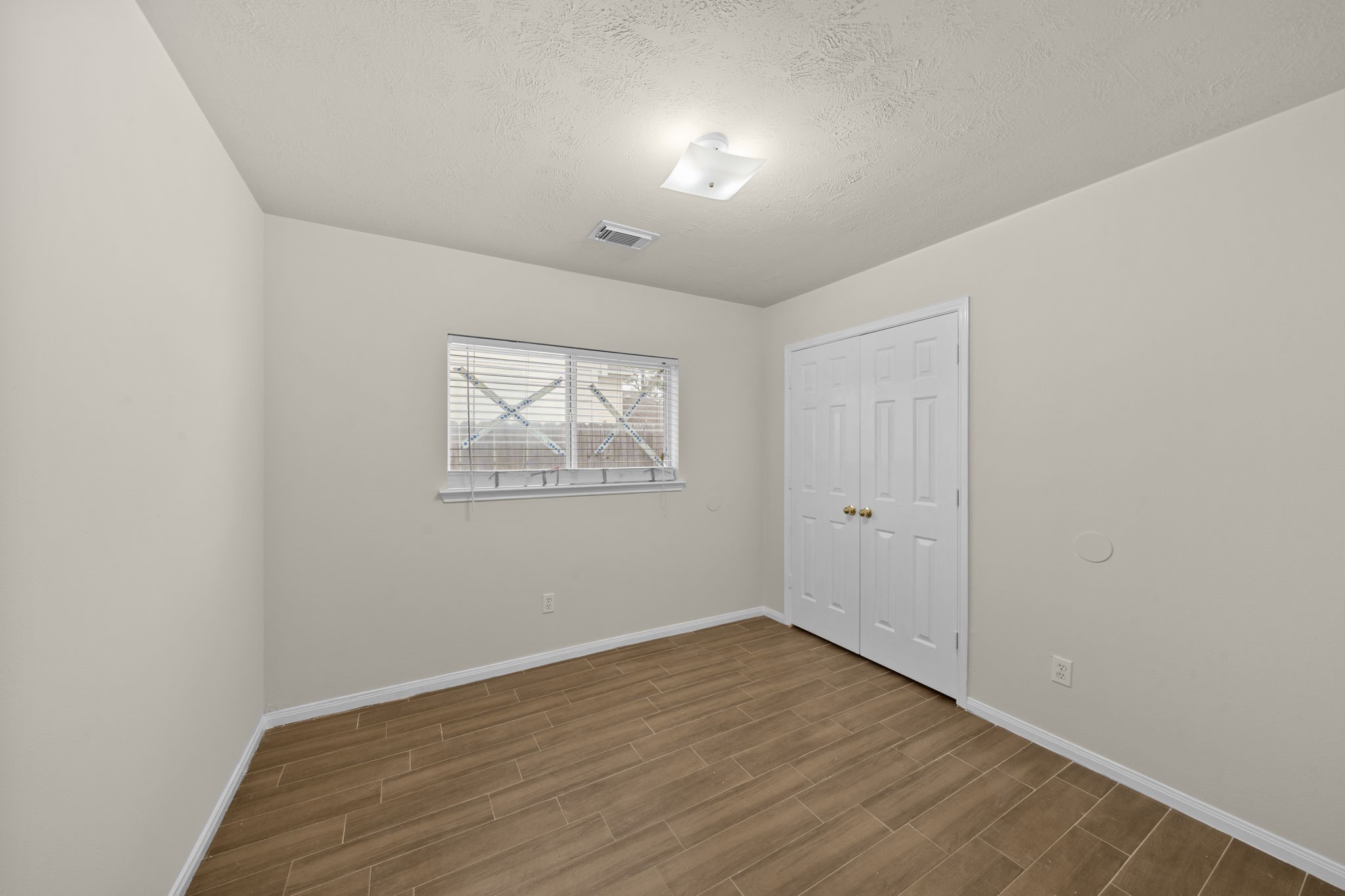 10330 Turrett Point Lane Houston, TX 77064 - Photo 12 of 15 an empty room with wooden floor and windows