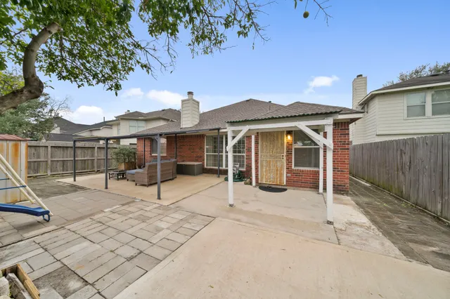 a view of a house with backyard and sitting area