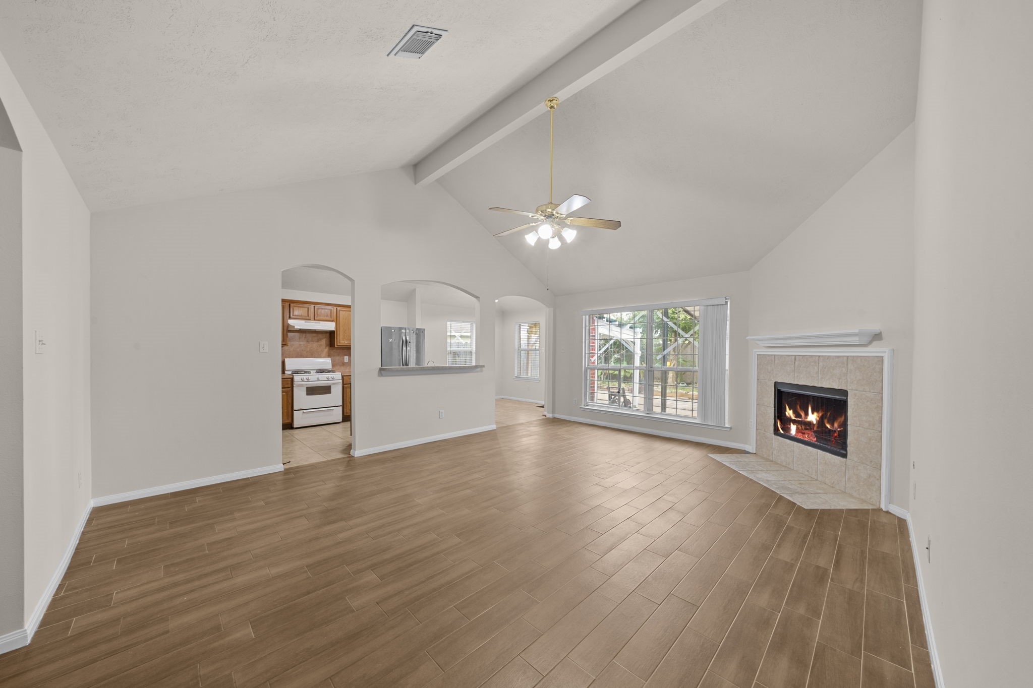 10330 Turrett Point Lane Houston, TX 77064 - Photo 2 of 15 an empty room with windows fireplace and cabinet