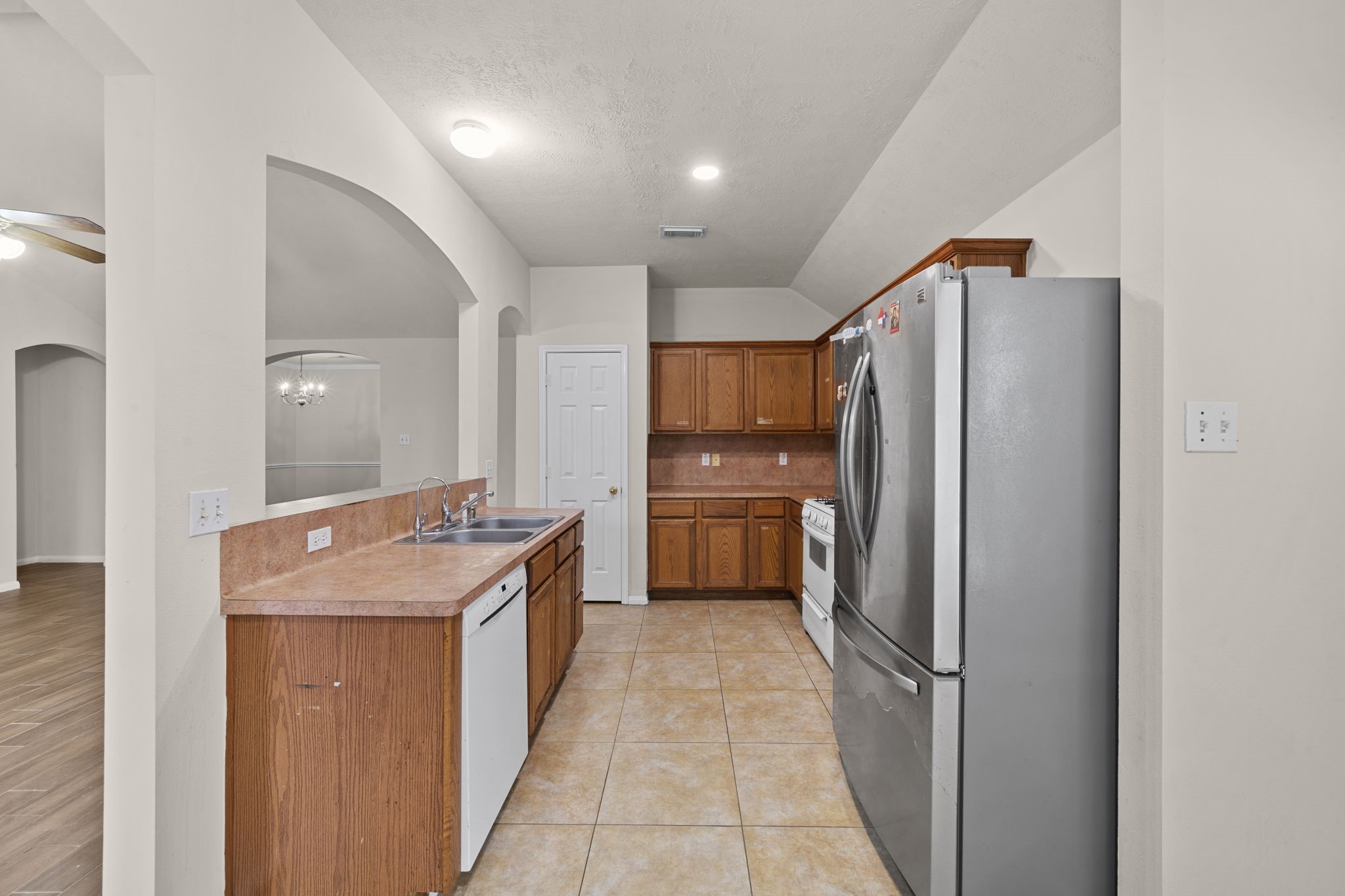 10330 Turrett Point Lane Houston, TX 77064 - Photo 4 of 15 a kitchen with a refrigerator and a sink