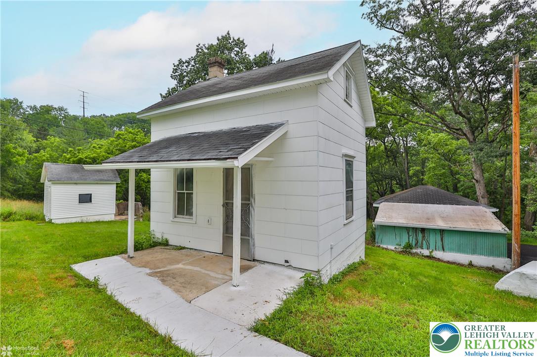 1911 Echo Road Slatington, PA 18080 - Photo 10 of 38 a view of a white house with a small yard and a large tree