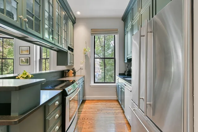 a kitchen with stainless steel appliances a sink and cabinets