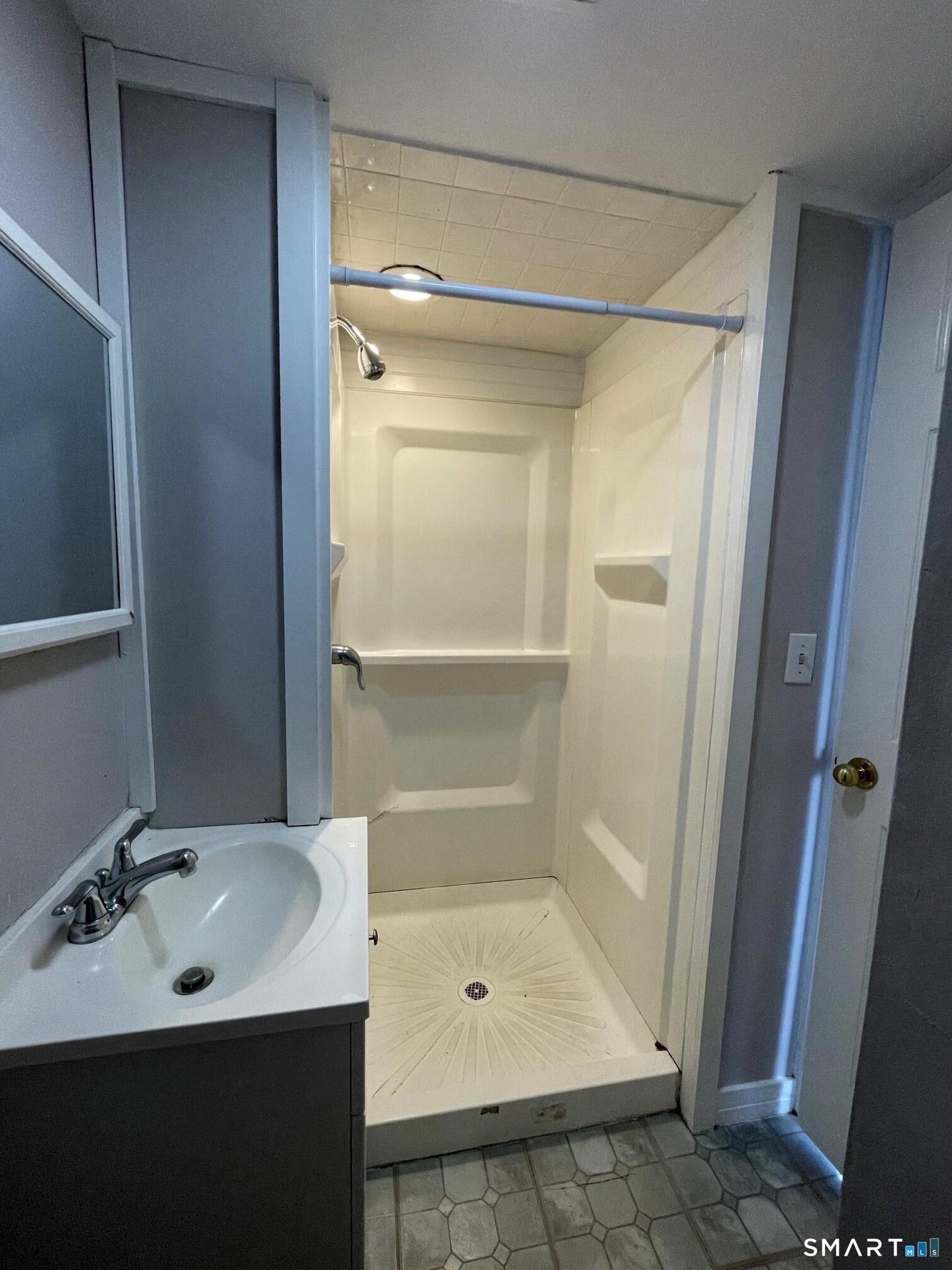 18 Old South Cove Road Old Saybrook, CT 06475 - Photo 34 of 40 a bathroom with a sink shower and a mirror