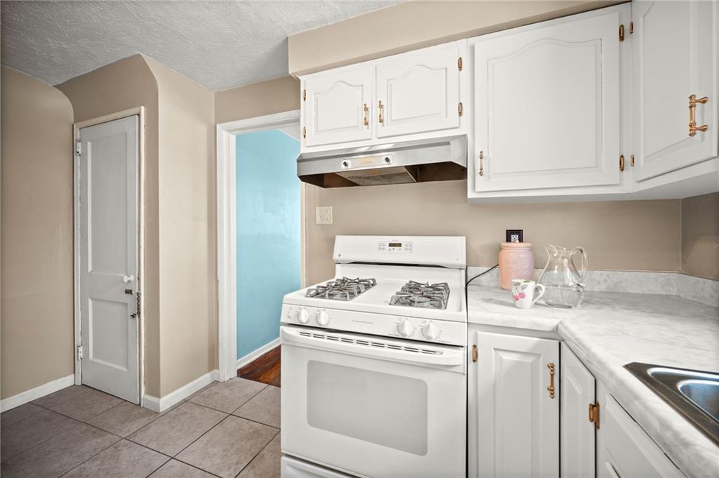2079 Spring Valley Road Pittsburgh, PA 15243 - Photo 12 of 35 a kitchen with white cabinets and white appliances