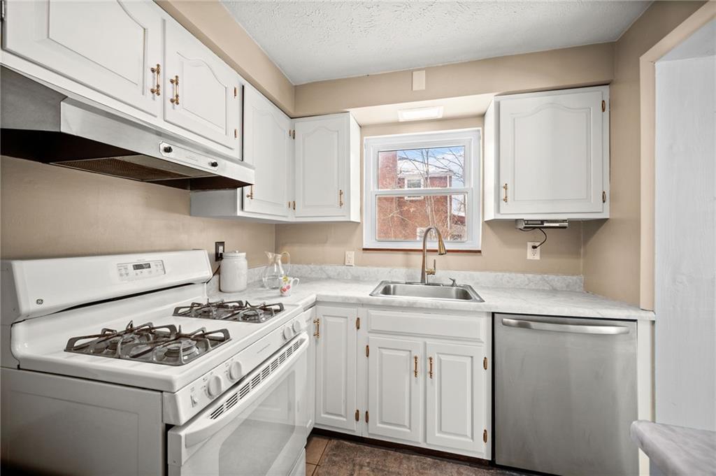 2079 Spring Valley Road Pittsburgh, PA 15243 - Photo 14 of 35 a kitchen with white cabinets sink and white appliances