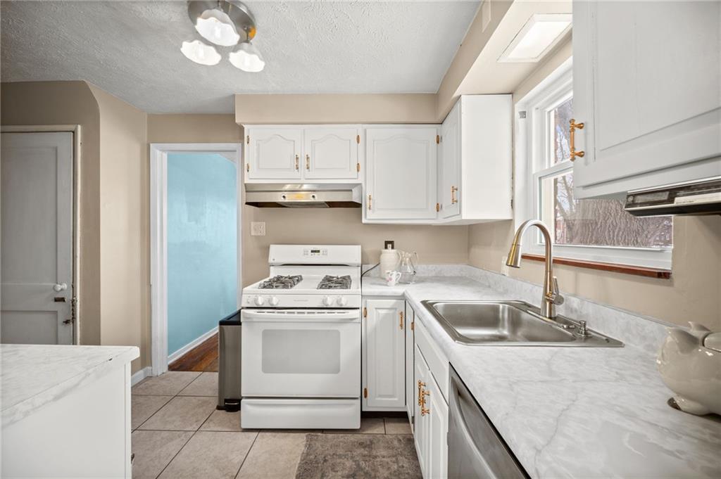 2079 Spring Valley Road Pittsburgh, PA 15243 - Photo 16 of 35 a kitchen with a sink a stove and cabinets
