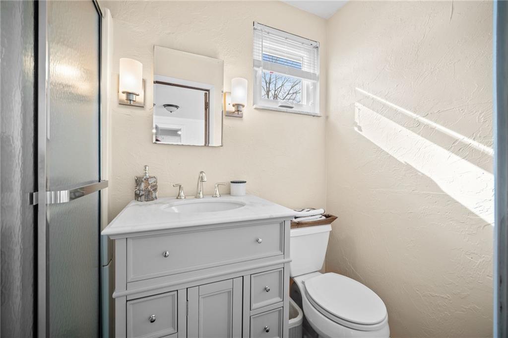 2079 Spring Valley Road Pittsburgh, PA 15243 - Photo 23 of 35 a bathroom with a toilet a sink a vanity and mirror