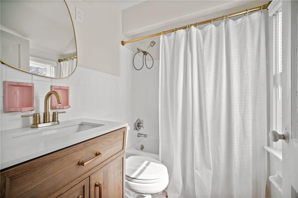 2079 Spring Valley Road Pittsburgh, PA 15243 - Photo 26 of 35 a bathroom with a sink a toilet and shower curtain