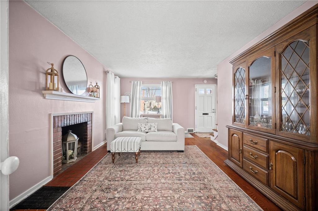 2079 Spring Valley Road Pittsburgh, PA 15243 - Photo 4 of 35 a living room with furniture a window and a fireplace