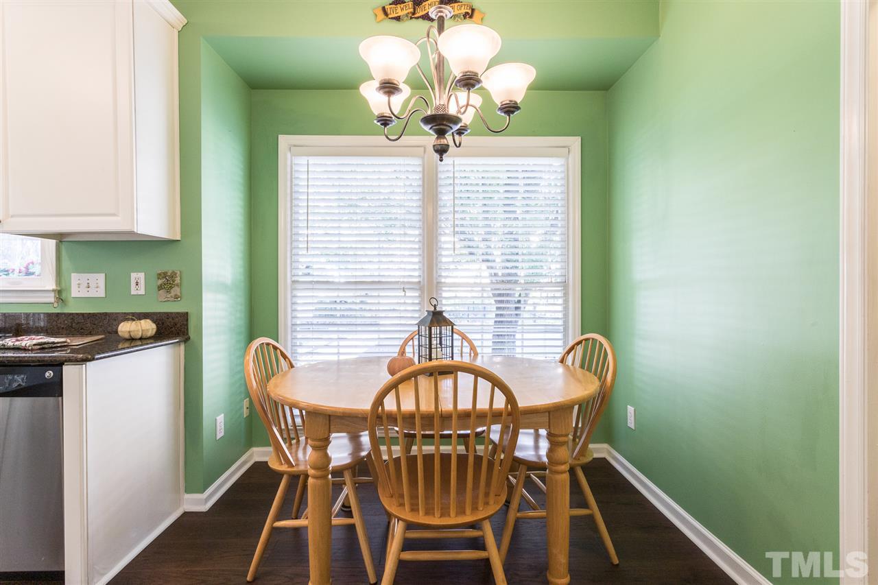 8612 Swarthmore Drive Raleigh, NC 27615 - Photo 14 of 30 a view of a dining room with furniture wooden floor and chandelier