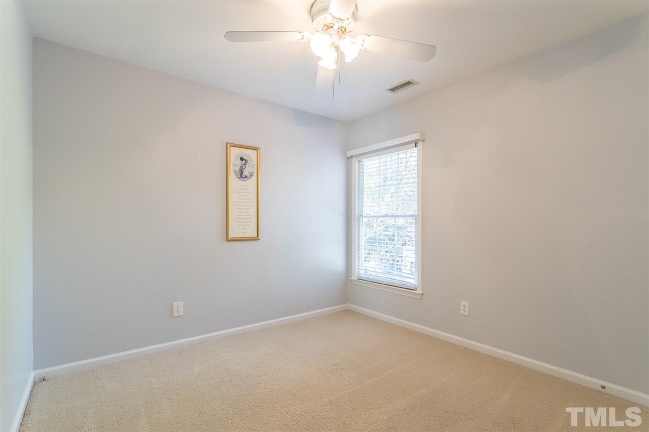 8612 Swarthmore Drive Raleigh, NC 27615 - Photo 22 of 30 an empty room with a window and a ceiling fan
