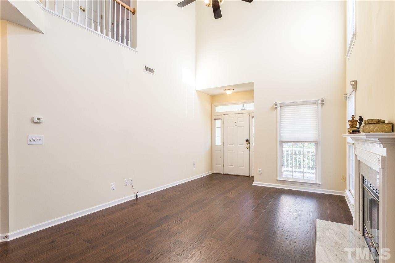 8612 Swarthmore Drive Raleigh, NC 27615 - Photo 9 of 30 a view of an empty room with wooden floor and a window