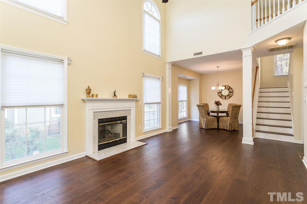 8612 Swarthmore Drive Raleigh, NC 27615 - Photo 10 of 30 a view of a livingroom with wooden floor a fireplace and window